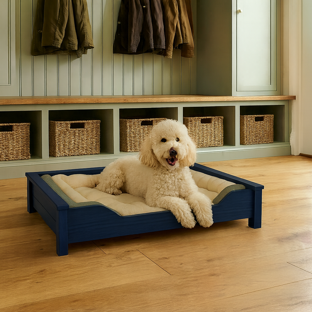 Cream-colored dog relaxing on a blue Barkminster bed in a mudroom